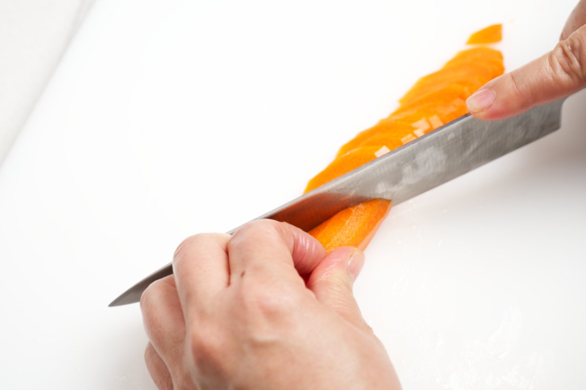 slicing carrot on diagonal for stuffed cucumber kimchi