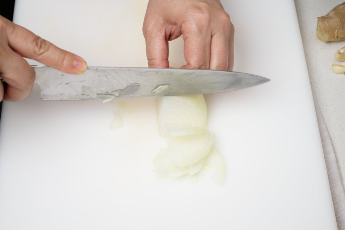 thinly slicing onion