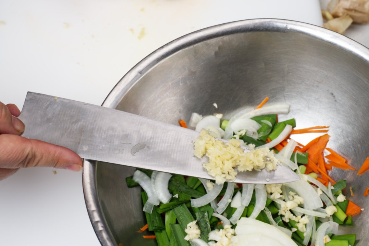 adding ginger to stuffed cucumber kimchi