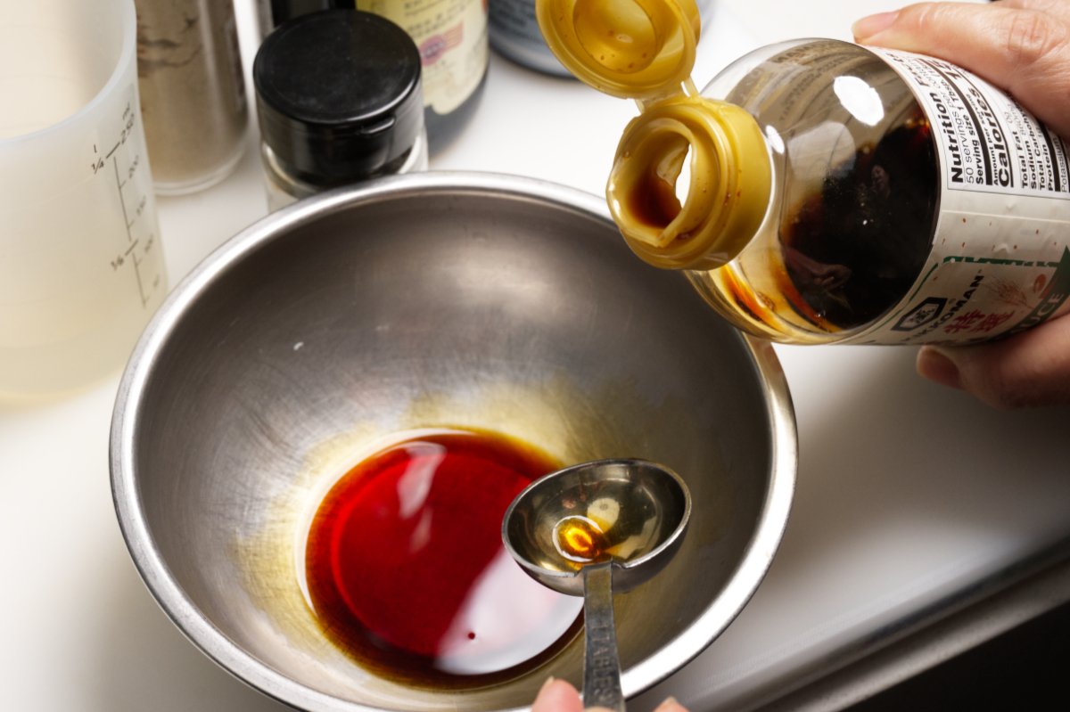 adding sesame oil to Chinese-style eggplant salad