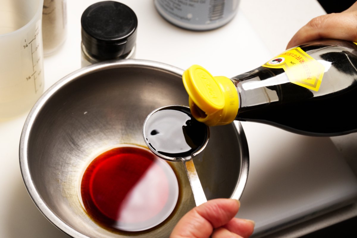 adding black vinegar to dressing for eggplant salad