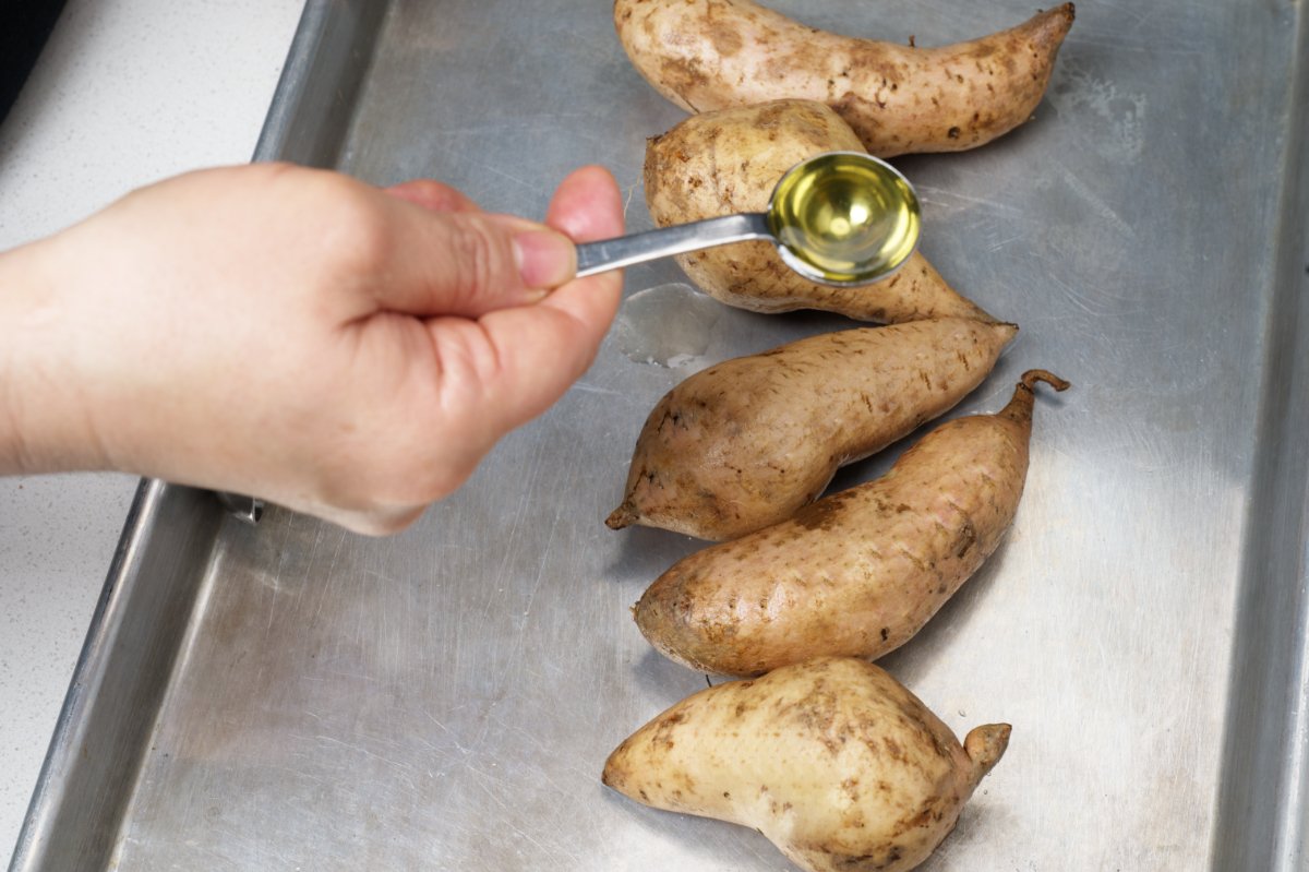 putting oil on potatoes slow roasted okinawan potatoes 