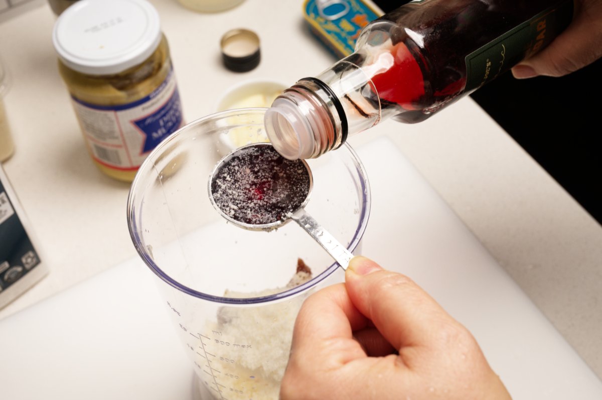 adding red wine vinegar to dressing for kale caesar salad