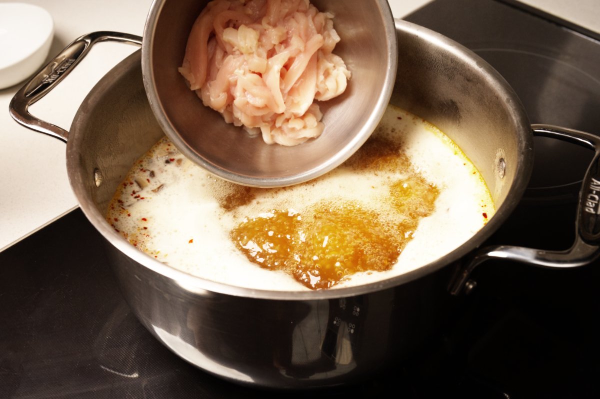 adding chicken strips to hot and sour soup