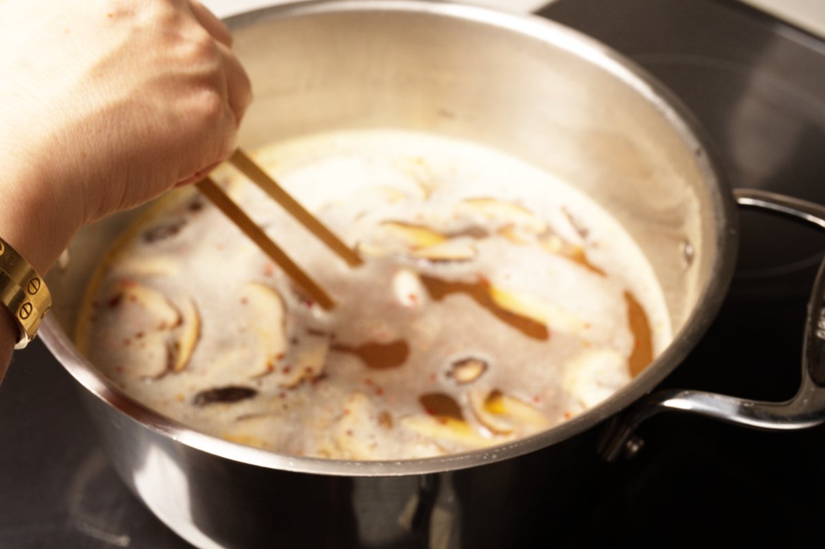 usig chopsticks to separate chicken