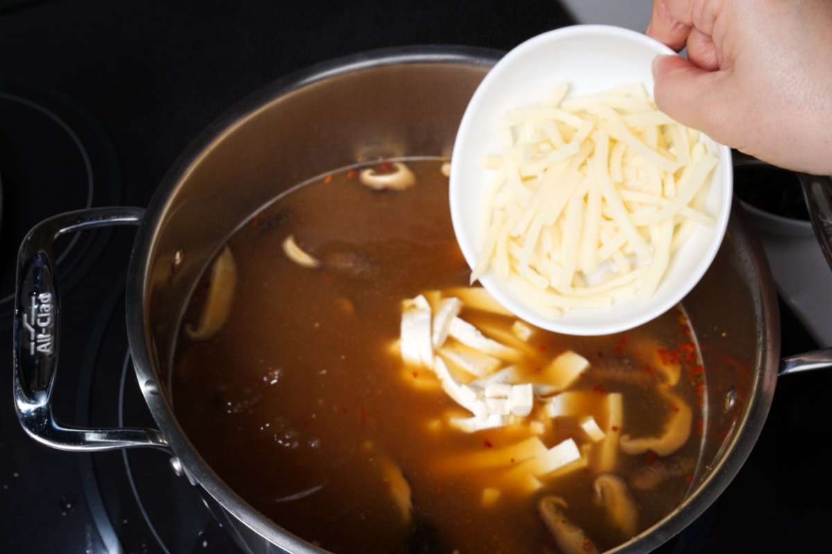 adding bamboo to hot and sour soup
