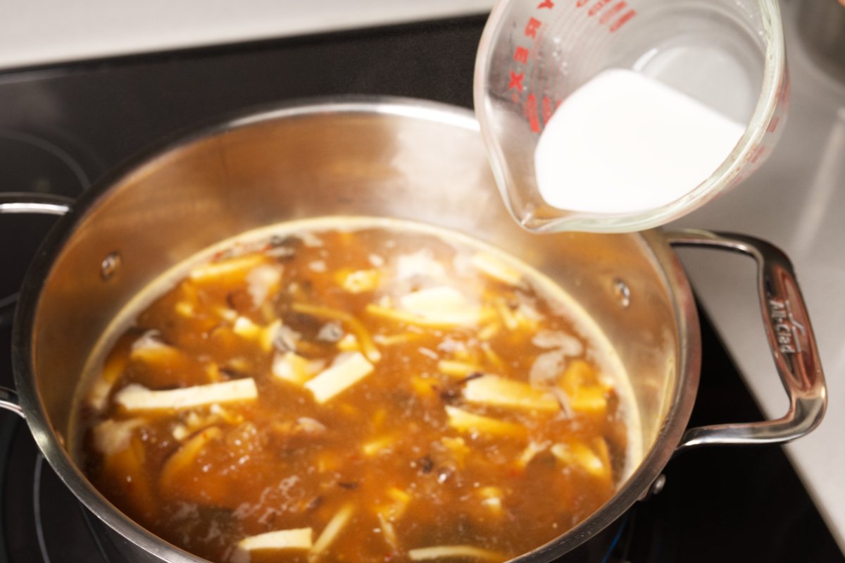 adding slurry to soup
