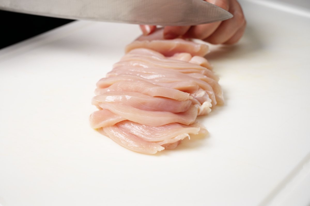 cutting chicken breast into thin strips for hot and sour soup
