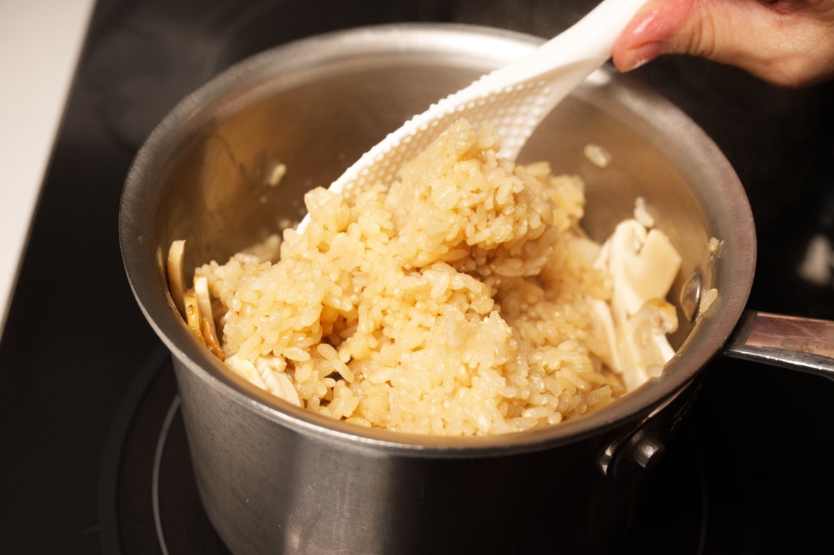 stirring mushrooms into rice