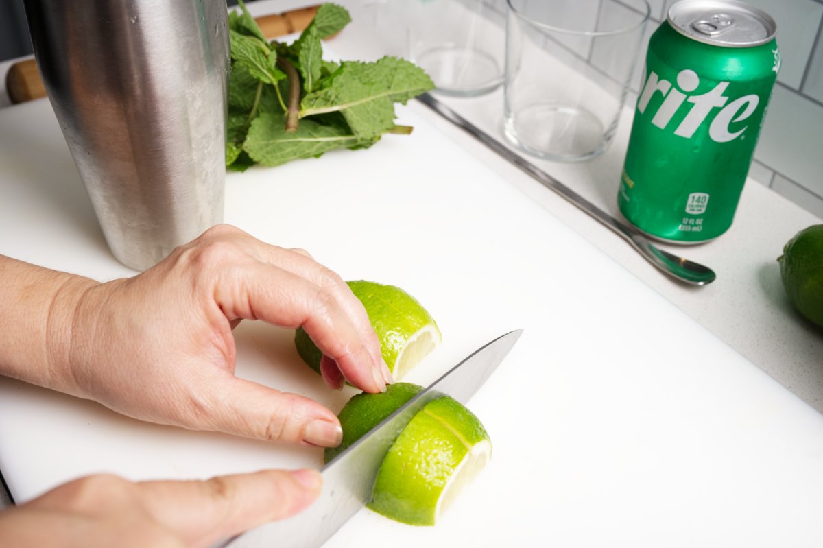 cutting limes into wedges for sake mojito