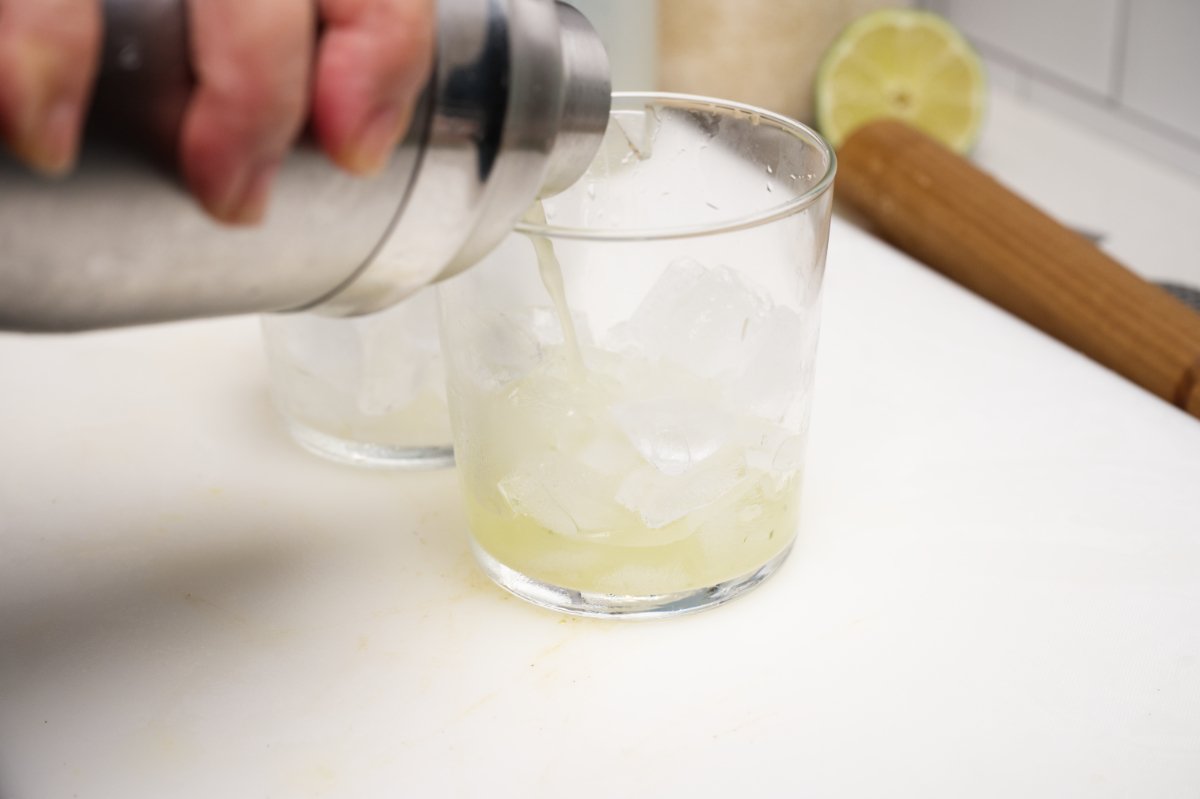 straining sake mojito into glasses
