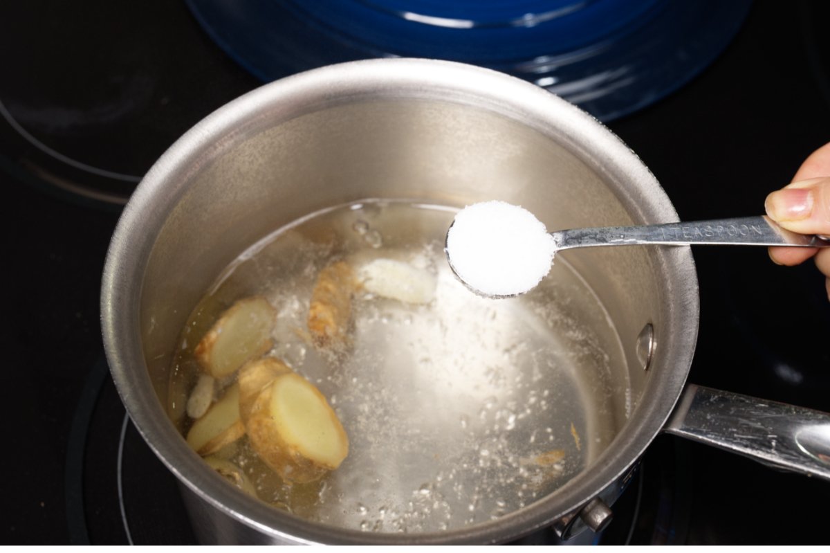 adding salt to the shrimp poaching water