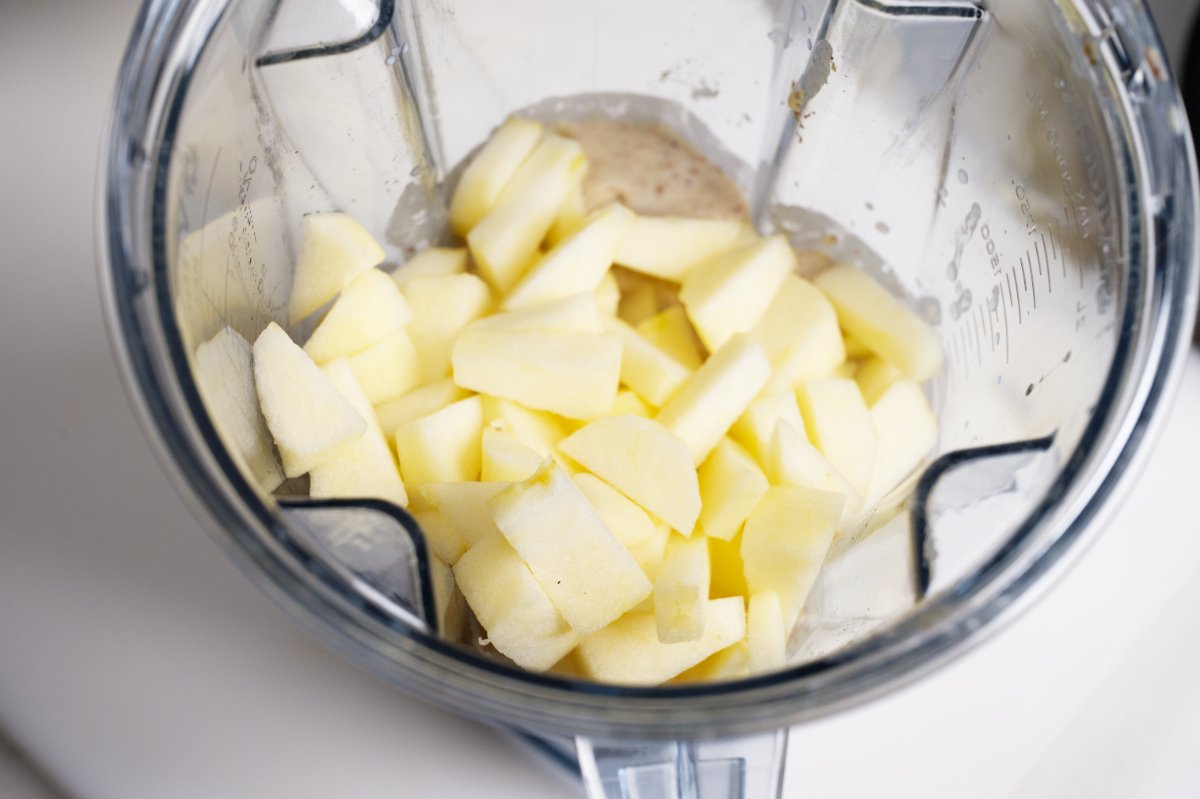 adding the apple to the blender
