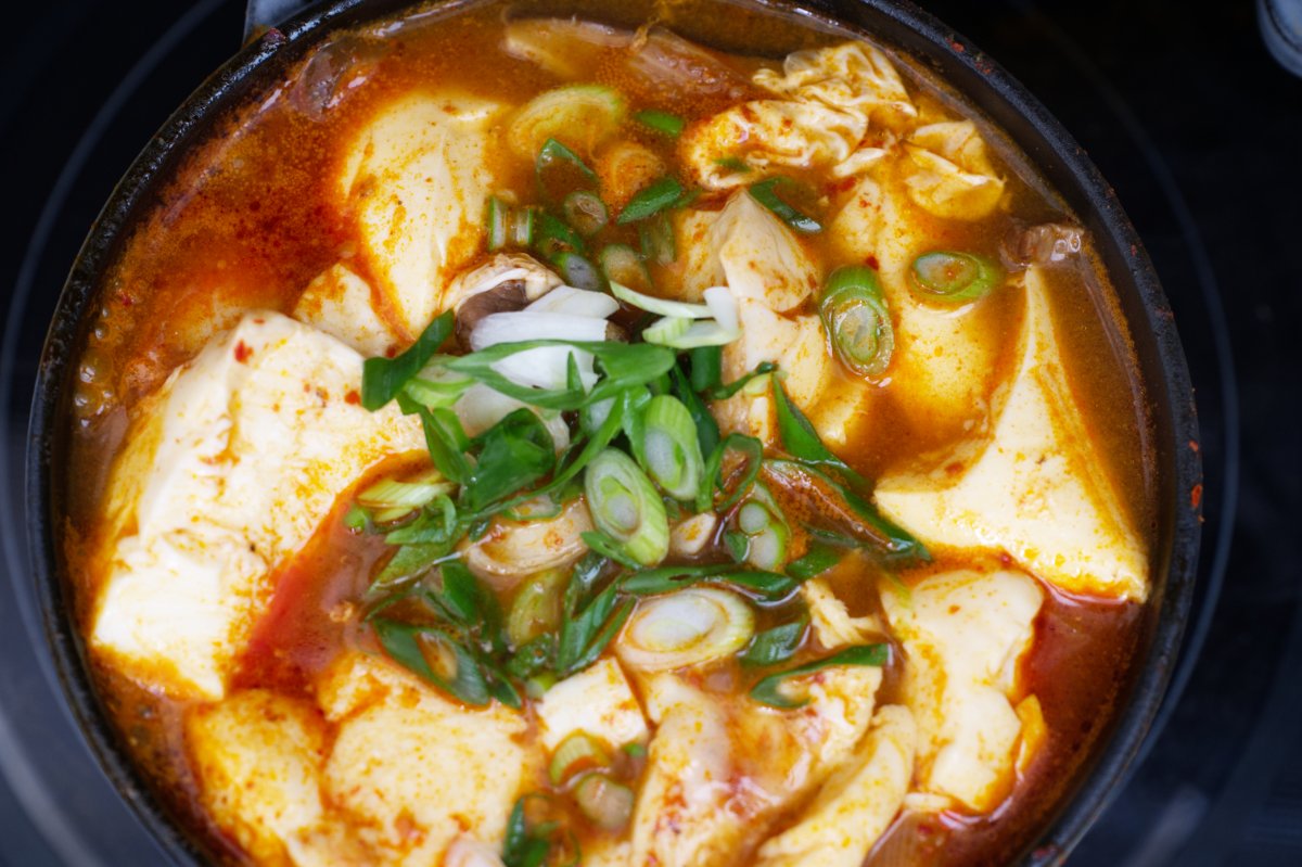 garnishing beef sundubu-jjigae