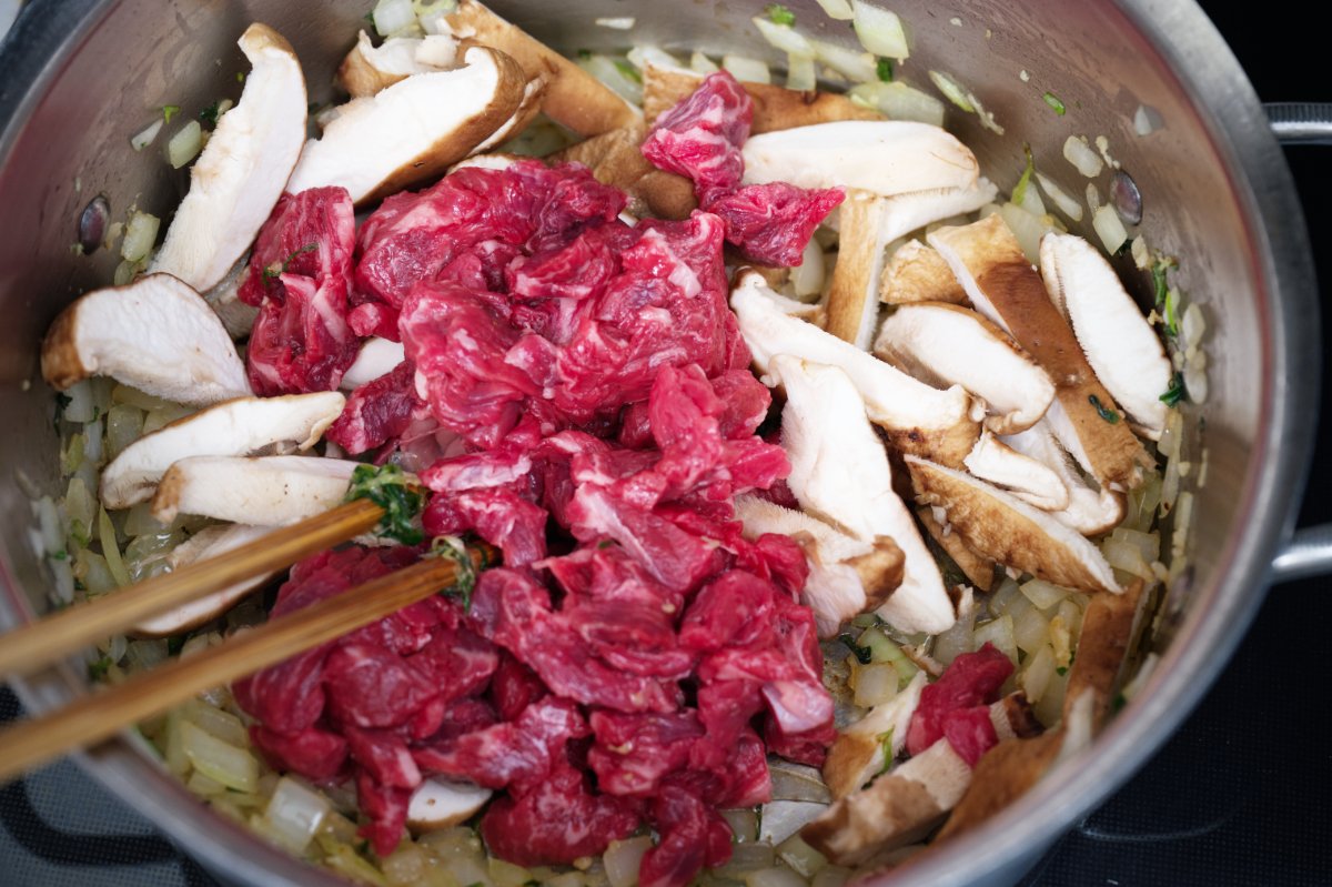 add the meat and shiitakes to beef sundubu-jjigae