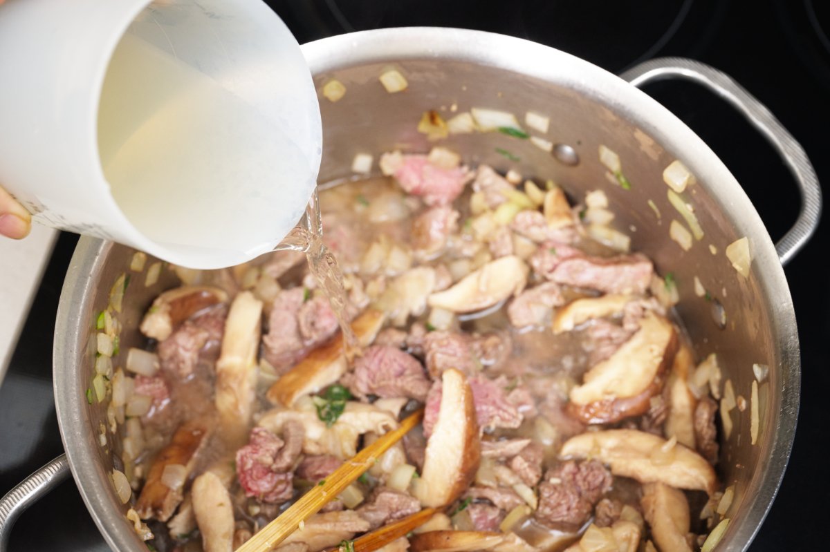 pouring the stock in beef sundubu-jjigae