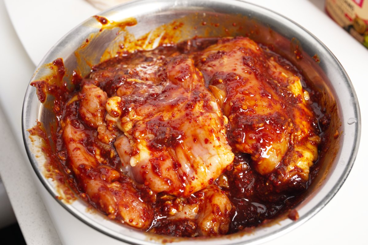 marinating the chicken in spicy braise